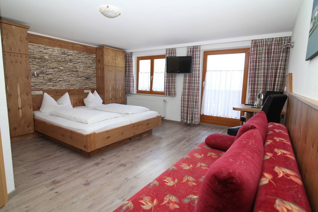 Doppelzimmer mit Zirbenholzbett und Steinvand